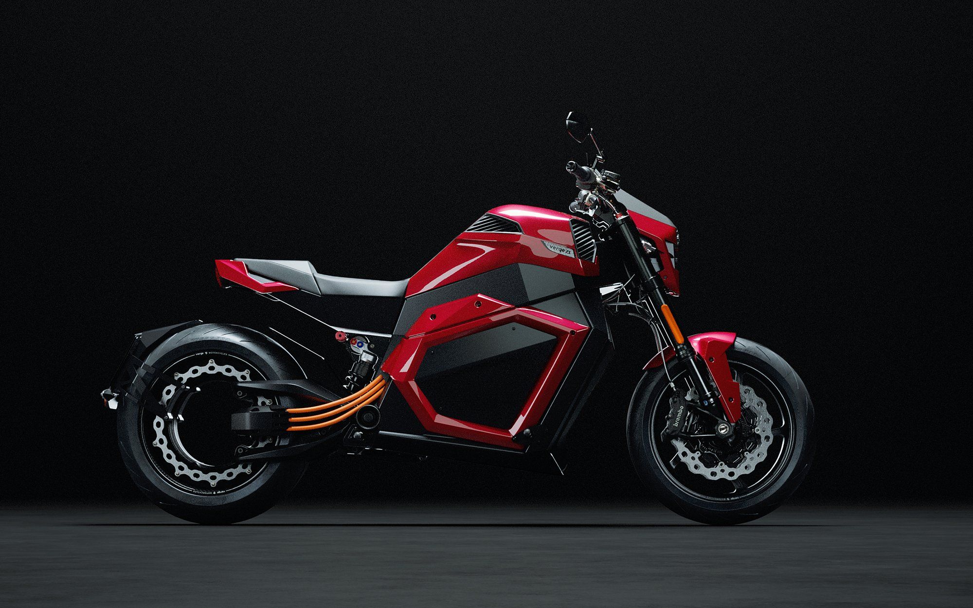 A bright red motorcycle is seen from the side.pro model.