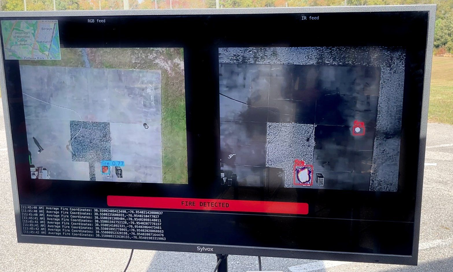 A computer screen shows two aerial images and a red warning that reads u201cFire Detectedu201d. 
